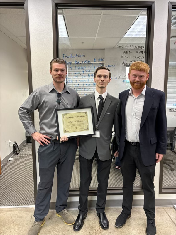 Team member receiving a promotion certificate